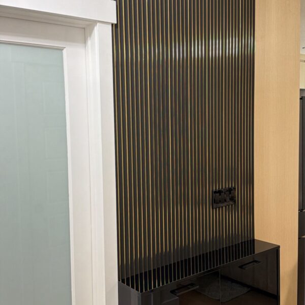black and gold fluted wall panel with floating cabinet feature wall Calgary